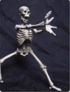 a skeleton is dancing in the dark with its arms out and legs spread wide open