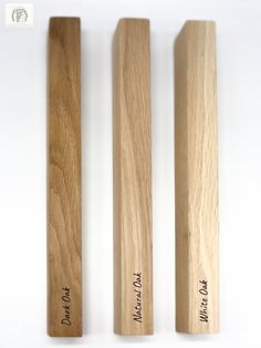 three wooden crochet hooks with writing on them sitting next to each other in front of a white background