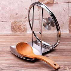 a wooden spoon sitting on top of a metal stand