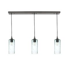 three lights that are hanging from a long light fixture with glass jars on the bottom