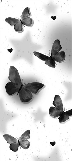 some black and white butterflies flying in the air with hearts on it's wings