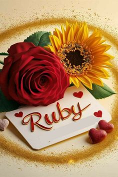 two red roses and one yellow rose on a white card with the word ruby written in gold