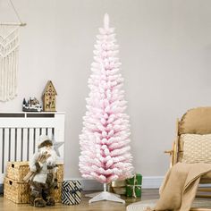 a pink christmas tree in the corner of a room