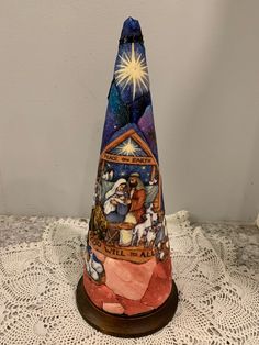 a small christmas cone with nativity scene on it