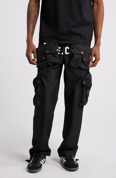 These cotton-blend cargo pants have an array of pockets and a slouchy silhouette for a streat-ready look. 30 1/2" inseam; 18" leg opening; 13" front rise; 16" back rise (size Medium) Elastic/drawstring waist Front snap-patch pockets; cargo snap-patch pockets; back decorative pocket flaps Lined 63% cotton, 37% nylon Hand wash, dry flat Imported Black Owned/Founded Heat Index, Billionaire Boy, Billionaire Boys Club, Fabric Gift Bags, Nordstrom Store, Fabric Gifts, Free Fabric, Black Fits, Cargo Pants