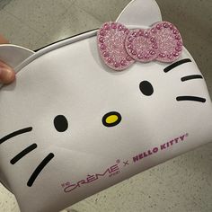 a hello kitty purse with pink sequins and a bow on the front pocket