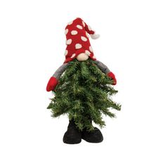 a gnome sitting on top of a christmas tree