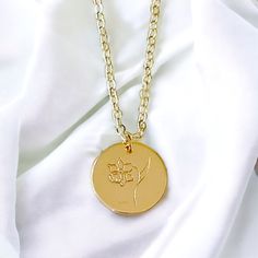 This Birth Month Flower Pendant Necklace is the ideal gift to celebrate a special birth month. With its elegant flower design, it is a thoughtful way to show your loved ones how much you care. Consider giving this unique piece of jewelry as a token of your affection. Material: 14K gold filled and plated Chain: 14K gold filled 16.5” Rolo chain Pendant: 14K gold plated hand stamped flower Lead and nickel free Delivered in a soft protective jewelry pouch and gift box Crafted in the USA Ships from M Birth Flower Medallion Necklace Gift, Dainty Birth Flower Medallion Necklace, Elegant Birth Flower Necklace As A Gift For Mom, Anniversary Flower Necklace With Birth Flower In Round Shape, Flower Shaped Jewelry With Flower Charm As Gift, Birth Flower Medallion Necklace For Anniversary, Medallion Birth Flower Necklace For Mother's Day, Medallion Necklace With Birth Flower For Mother's Day, Elegant Flower Charm Necklace With Birth Flower