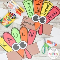 some paper turkeys are on the table with markers and crayons