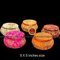 five different types of round boxes with gold and pink designs on the sides, all in various