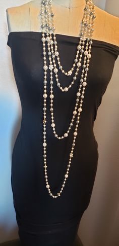 Description: Inspired to accessorize that black dress worn by Audrey Hepburn in Breakfast at Tiffany's, this beautiful extra long Vintage style Multi strand faux pearl necklace is sure to garner attention and turn heads! Really adds flare to that 'little Black Dress" This is a Chandra's Treasures original piece. I use beautiful lustrous imitation pearls for this piece with double sided black and white floral motifs containing a small faux pearl centerpiece. There are many ways to wear this neckl Layer Pearl Necklace, Statement Pearl Necklace, Pearl Necklace Long, Pearl Centerpiece, Multi Strand Pearl Necklace, Layered Pearl Necklace, Pearl Statement Necklace, Long Pearl Necklaces, Breakfast At Tiffany's