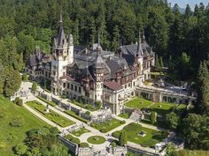 an aerial view of a large mansion in the woods