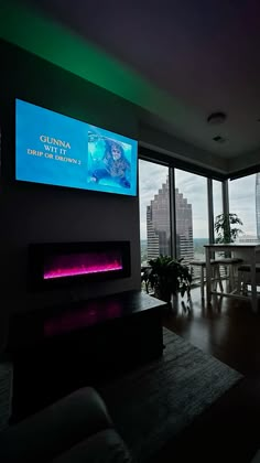 a living room filled with furniture and a flat screen tv mounted to the side of a wall