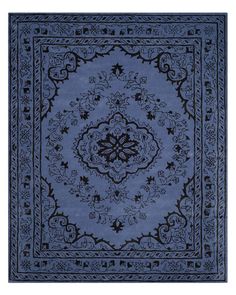 a blue rug with an intricate design on the top and bottom, surrounded by small black flowers