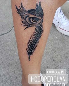 a close up of a person's leg with a bird tattoo on the side