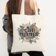 "Show off your love for your cat with this Retro Floral Cat Mama Tote Bag! This 100% cotton bag comes in one size - 15\" x 16\"- perfect for everyday wear. The canvas material is durable and will last for years. The bag features 20\" handles (made from the same canvas), making it easy to carry a week's worth of shopping or supplies for a day at the pumpkin patch. It also makes a great gift for any cat mama. Grab one for yourself and a friend! .: 100% cotton canvas .: Heavy fabric (12 oz/yd² (406.9 g/m .: Sewn-in label .: Flat Corners .: Carry handles with reinforced stitching Care Instructions: Do not wash Returns/Exchanges: Because these tote bags are made to order, they cannot be returned or exchanged. Please contact me through Etsy email if you have a problem with your order. Happy to h Casual Cotton Bag With Cat Print, Rectangular Cotton Bag With Cat Design, Eco-friendly Bags With Cat Design For Gift, Cotton Bag With Cat Print, Rectangular Shape, Rectangular Cotton Bag With Cat Print, Daily Use Cotton Bags With Cat Design, Eco-friendly Cat Design Bags For Gifts, Eco-friendly Cat Design Bags As Gift, Cotton Cat Print Rectangular Bag