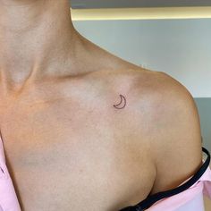 a woman with a small crescent tattoo on her chest