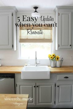 a white kitchen sink sitting under a window