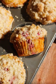 freshly baked muffins with crumbs on a baking tray ready to be eaten