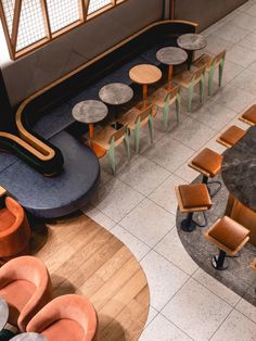 an overhead view of a restaurant with tables and chairs in the center, looking down at the seating area