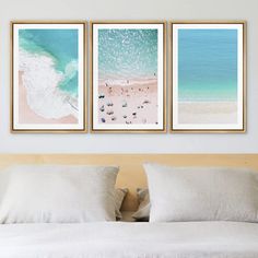 three pictures hanging on the wall above a bed