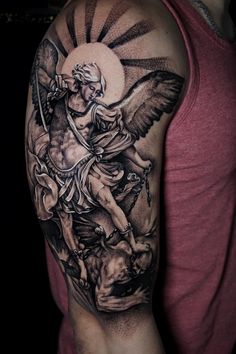 a man's arm with an angel on it and a sun in the background