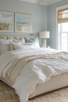 a bedroom with blue walls and white bedding