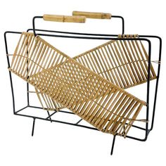 a bamboo and metal rack with wooden handles