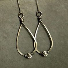 Eco friendly sterling silver (16G) has been hand formed and hammered into teardrops. An organic spiral has been wire wrapped around a 4mm cream Swarovski pearl. The teardrops have been oxidized and lightly brushed with steel wool and then polished for a soft patina. Ear wires are hand formed from sterling silver. Earrings measure 2.75 inches from top of ear wire to bottom of teardrop. All silver used has come from a recycled source. All pieces come in a craft box wrapped in a ribbon that is tied Classic Handmade Teardrop Hoop Earrings, Simple Metal Jewelry For Pierced Ears, Classic Metal Teardrop Earrings As Gift, Classic Metal Teardrop Earrings For Gift, Simple Nickel-free Metal Earrings, Everyday Handmade Metal Teardrop Earrings, Wire Wrapped Teardrop Earrings For Anniversary, Classic Handmade Teardrop Earrings For Gifts, Minimalist Wire Wrapped Teardrop Earrings