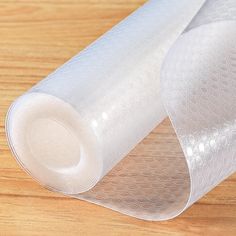 two rolls of clear bubble wrap sitting on top of a wooden table