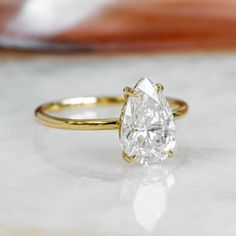 a close up of a diamond ring on a table