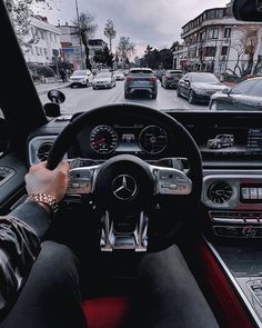 a person driving a car on a city street