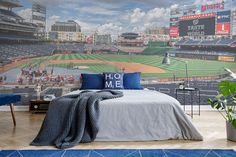 a bedroom with a baseball field mural on the wall and a blue rug in front of it