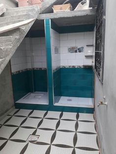 a bathroom with blue and white tiles on the floor, shower stall door opened up