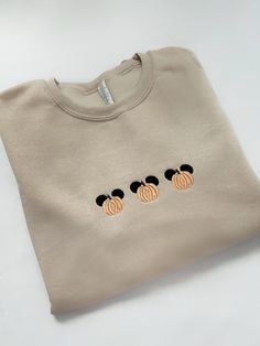 three mickey mouse ears embroidered on the back of a t - shirt