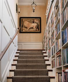 there is a staircase leading up to the bookshelves