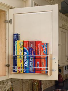 a kitchen cabinet filled with lots of different types of snacks and drinks on it's shelf