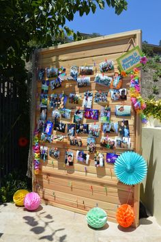 an outdoor display with pictures and decorations on the outside, along with paper fans in front of it