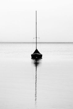 a sailboat floating on top of a large body of water