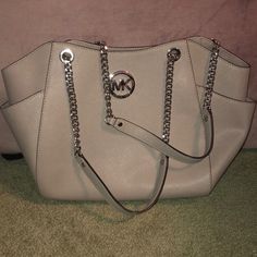 Saffiano Leather Gray And Silver Michael Kors Travel Jet Set Handbag. Like New Condition. Pockets On Either Side. Chain Handles. Gorgeous Bag! You Will Receive Many Compliments! Bag Dimensions: 11"-13"L X 9"H X 4” D; With 11"Shoulder Drop Travel Handbag, Bags Michael Kors, Travel Handbags, Gorgeous Bags, Kors Jet Set, Michael Kors Jet Set, Jet Set, Handles, Michael Kors