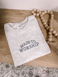 "Embroidered Made To Worship Minimalistic Tee Embroidery size: approximately 5\" in length (across chest) Sizes: UNISEX Small, Medium, Large, XLarge, 2Xlarge -Fit is a little loose Color: Ash Thread: Frost  Wash & Care: -Wash in cold water with like colors on a gentle cycle -Tumble dry low or hang to dry PROCESSING/TURNAROUND TIME: -Processing/Turn around times may vary. Please check the estimated ship/delivery times.  -Processing/Turn around time DOES NOT include shipping time. *PLEASE NOTE color resolutions in the photos may differ depending on devices. *This is a HONEY SOUL SHOP original design, do not copy* Embroidered Made To Worship Minimalistic Tee" Aesthetic Christian T Shirts, Embroidered Cotton Crew T-shirt, Made To Worship Shirt, Embroidered Cotton Short Sleeve Sweatshirt, Cotton Short Sleeve Sweatshirt With Embroidered Text, Crew Cotton Top With Machine Embroidery, Cotton Sweatshirt With Embroidered Text And Short Sleeves, Cotton Crew Top With Machine Embroidery, Cotton Crew Neck Top With Machine Embroidery