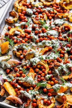 a sheet pan filled with baked potatoes and chickpeas