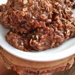 three cookies are stacked on top of each other in a white bowl with chocolate chips