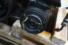 an old camera sitting on top of a wooden pallet