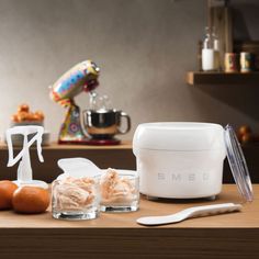 an assortment of food items on a countertop with utensils and mixers in the background