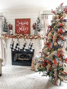 a decorated christmas tree in front of a fireplace