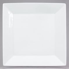 an empty white square plate on a gray background