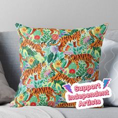 a pillow with an image of a tiger on it and the words support independent artists