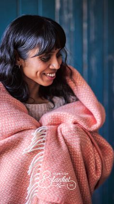 Smiling woman wrapped in a woven coral blanket. Coral Aesthetic, Coral Decor