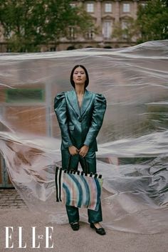 a woman standing in front of a plastic sheet